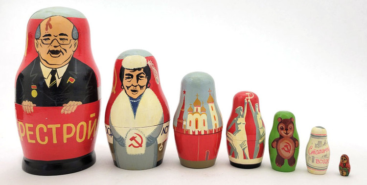 Gorbachev and Soviet Promo Matryoshka Doll. One of the more unusual, or perhaps original, Gorby dolls we've ever seen. It starts off in typical fashion with Mikhail Gorbachev in a brown suit with flag pin and medal standing against a large red banner with the word Перестройка (Perestroika, i.e, Reform Movement), and behind him another banner with a yellow hammer and sickle and star. After him, and keeping with the red banner theme, comes an indigenous woman in fur with the word Аэрофлот (Aeroflot, the, at the time, Soviet Airlines) in front of an airplane and more hammers, sickles and stars. The third piece is the Kremlin and its towers. Next is the Soviet statue of a pair holding a hammer and sickle: "Worker and Kolkhoz Woman", created for the 1937 World's Fair in Paris by Vera Mukhina. On the back is CCCP and a star. The next piece is a smiling bear cub with a hammer and sickle on its belly and more CCCP and a star. Nexxt to last is a representation of a Stolichnaya Vodka label and "Made in USSR" in English. The last piece is a tiny matryoshka girl. The doll is actually signed in Russian by the artist, but not dated. We estimate that it was painted pre-1991, perhaps 1988-1990, a souvenir representation of Soviet symbols and goods. Gorbachev and Soviet Promo Matryoshka Doll. One of the more unusual, or perhaps original, Gorby dolls we've ever seen. It starts off in typical fashion with Mikhail Gorbachev in a brown suit with flag pin and medal standing against a large red banner with the word Перестройка (Perestroika, i.e, Reform Movement), and behind him another banner with a yellow hammer and sickle and star. After him, and keeping with the red banner theme, comes an indigenous woman in fur with the word Аэрофлот (Aeroflot, the, at the time, Soviet Airlines) in front of an airplane and more hammers, sickles and stars. The third piece is the Kremlin and its towers. Next is the Soviet statue of a pair holding a hammer and sickle: "Worker and Kolkhoz Woman", created for the 1937 World's Fair in Paris by Vera Mukhina. On the back is CCCP and a star. The next piece is a smiling bear cub with a hammer and sickle on its belly and more CCCP and a star. Nexxt to last is a representation of a Stolichnaya Vodka label and "Made in USSR" in English. The last piece is a tiny matryoshka girl. The doll is actually signed in Russian by the artist, but not dated. We estimate that it was painted pre-1991, perhaps 1988-1990, a souvenir representation of Soviet symbols and goods.