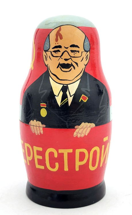 Gorbachev and Soviet Promo Matryoshka Doll. One of the more unusual, or perhaps original, Gorby dolls we've ever seen. It starts off in typical fashion with Mikhail Gorbachev in a brown suit with flag pin and medal standing against a large red banner with the word Перестройка (Perestroika, i.e, Reform Movement), and behind him another banner with a yellow hammer and sickle and star. After him, and keeping with the red banner theme, comes an indigenous woman in fur with the word Аэрофлот (Aeroflot, the, at the time, Soviet Airlines) in front of an airplane and more hammers, sickles and stars. The third piece is the Kremlin and its towers. Next is the Soviet statue of a pair holding a hammer and sickle: "Worker and Kolkhoz Woman", created for the 1937 World's Fair in Paris by Vera Mukhina. On the back is CCCP and a star. The next piece is a smiling bear cub with a hammer and sickle on its belly and more CCCP and a star. Nexxt to last is a representation of a Stolichnaya Vodka label and "Made in USSR" in English. The last piece is a tiny matryoshka girl. The doll is actually signed in Russian by the artist, but not dated. We estimate that it was painted pre-1991, perhaps 1988-1990, a souvenir representation of Soviet symbols and goods. Gorbachev and Soviet Promo Matryoshka Doll. One of the more unusual, or perhaps original, Gorby dolls we've ever seen. It starts off in typical fashion with Mikhail Gorbachev in a brown suit with flag pin and medal standing against a large red banner with the word Перестройка (Perestroika, i.e, Reform Movement), and behind him another banner with a yellow hammer and sickle and star. After him, and keeping with the red banner theme, comes an indigenous woman in fur with the word Аэрофлот (Aeroflot, the, at the time, Soviet Airlines) in front of an airplane and more hammers, sickles and stars. The third piece is the Kremlin and its towers. Next is the Soviet statue of a pair holding a hammer and sickle: "Worker and Kolkhoz Woman", created for the 1937 World's Fair in Paris by Vera Mukhina. On the back is CCCP and a star. The next piece is a smiling bear cub with a hammer and sickle on its belly and more CCCP and a star. Nexxt to last is a representation of a Stolichnaya Vodka label and "Made in USSR" in English. The last piece is a tiny matryoshka girl. The doll is actually signed in Russian by the artist, but not dated. We estimate that it was painted pre-1991, perhaps 1988-1990, a souvenir representation of Soviet symbols and goods.