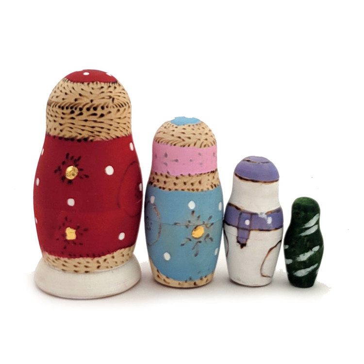 Grandfather Frost with Friends.  Grandfather Frost, carrying a sack full of Christmas gifts, is joined by the Snowmaiden and a jolly decorated Snowman. Rounding out the set is a small green tree flecked with snow. A nice set from about 7 years ago using paints and woodburnt skills. From Sergiev Posad. 4 nest, 2¾" to 1".