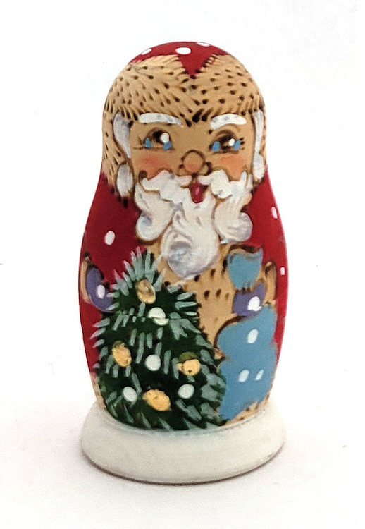 Grandfather Frost with Friends.  Grandfather Frost, carrying a sack full of Christmas gifts, is joined by the Snowmaiden and a jolly decorated Snowman. Rounding out the set is a small green tree flecked with snow. A nice set from about 7 years ago using paints and woodburnt skills. From Sergiev Posad. 4 nest, 2¾" to 1".