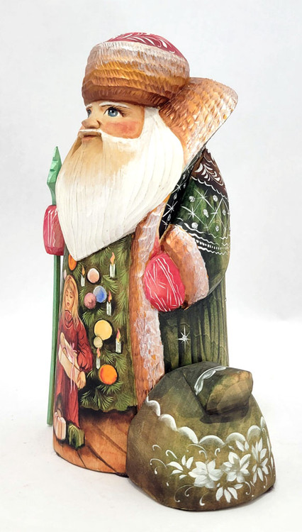 Grandfather Frost with Painted Christmas Morning Scene (Дед Мороз на фоне расписанной сцены рождественского утра). An elegant combination of detailed carving and painting. A young girl unwraps her present revealing a doll. Several more gifts are at her feet. The tree is decorated with globe ornaments and candles. Excellent detail. Sergiev Posad carving circa 2010.