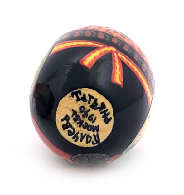 Babushka Knitting (Бабушка вяжет носок). Kindly grandmother knits a brightly colored sock. Signed by artist, dated 1990. Made in Moscow. 3".