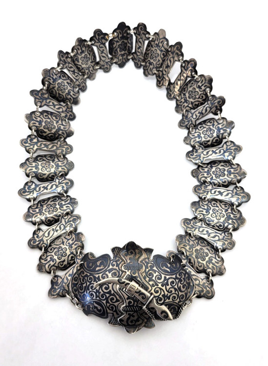 Russian 84 Silver Engraved Niello from Caucasus, early 20th c. Russian empire hallmarks indicating Kiev throughout. Hand forged with intricate chased engraved designs. Large buckle is latched by a clasp in the form of a miniature dagger on a chain. All parts are marked 84 for silver purity assay and maker's identification mark [LK]. 7oz (198 grams). On the small side (for a younger waist). 26½" in length, buckle is 2½" and segments 2".
