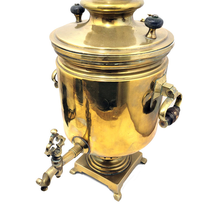 Large and heavy pre-revolutionary brass samovar.  1890-1910. Tula, Russia. In about fine condition, no major dents or missing parts. The golden brass is warm quality and has been cleaned often by the former owner. About 19¾" in height and weighs slightly over 13½ lbs. The inside chamber has calcium and mineral deposits indicative of prior use. The burn chamber plate, essentially a grill, is intact and clips on.  All parts, including key, grips, cap, etc., appear to be original.e factory award medals and identification has been polished nearly out of existence, but a closer look reveals the word "Ivan" and "Batashev". The era is 1890-1910. Ivan Grigoryevich Batashev is one of the most famous and well-known samovar makers in Tula