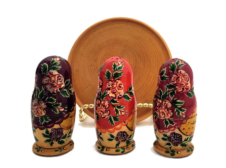 Matryoshka Seasoning Trio. An adorable set of maidens from Sergiev Posad, probably 1990 or a bit earlier. Each matryoshka opens to house either salt, papper, or cayenne (?). Titles in English indicating was made for an export market. Tray seems to have been added later. All wood, and all hand decoration. Both decorative and functional.  Dolls just under 3¼" in height, tray just under 4¼" in diameter.
