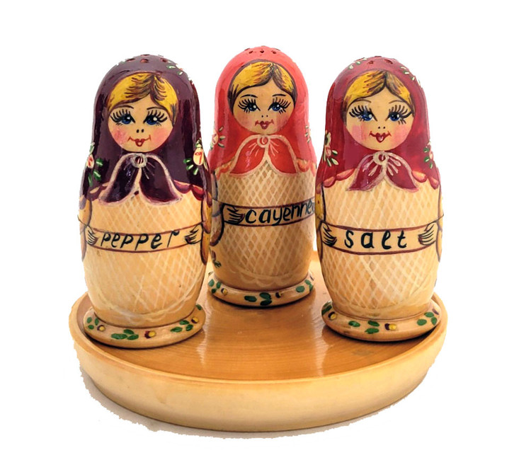 Matryoshka Seasoning Trio. An adorable set of maidens from Sergiev Posad, probably 1990 or a bit earlier. Each matryoshka opens to house either salt, papper, or cayenne (?). Titles in English indicating was made for an export market. Tray seems to have been added later. All wood, and all hand decoration. Both decorative and functional.  Dolls just under 3¼" in height, tray just under 4¼" in diameter.