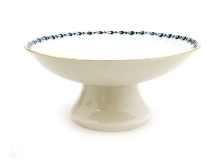 Cobalt Frieze Compote, or Candy Dish. The glamour of Cobalt Frieze reflects the high regard in which Classicism was held in Russian porcelain manufactory. It was here that restrained naturalism and formal classical beauty forged the ideal traditions of Empire china. This version of the venerable, since discontinued, pattern uses 22Kt gold enhancements and cobalt blue on a milky white background (pictures don't do the white justice). Blue Lomonosov export mark circa 2005.