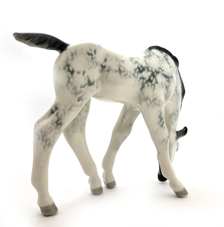 Dapple Gray Foal Lomonosov Porcelain. Also known as Pastured Colt. A vintage horse sculpture that was designed by Boris Yakovlevich Vorobiev (1911-1990), who was associated with the Lomonosov Porcelain Factory (LFZ) beginning in 1936 and ending in about 1980 due to illness. Hand painted hard paste porcelain in about new condition (small mark on the underside is a "release" mark incurred in the factory). 9⅝" x 3⅛" x 7½"