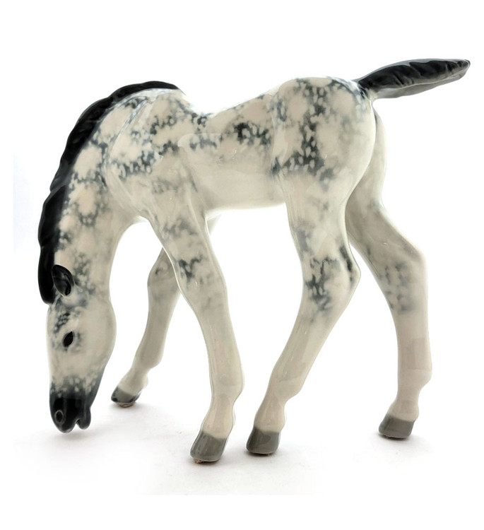 Dapple Gray Foal Lomonosov Porcelain. Also known as Pastured Colt. A vintage horse sculpture that was designed by Boris Yakovlevich Vorobiev (1911-1990), who was associated with the Lomonosov Porcelain Factory (LFZ) beginning in 1936 and ending in about 1980 due to illness. Hand painted hard paste porcelain in about new condition (small mark on the underside is a "release" mark incurred in the factory). 9⅝" x 3⅛" x 7½"