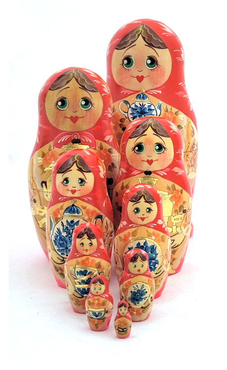 Golden Samovar Matryoshka (Матрешка Золотой самовар).  An early, fully handmade and painted 9-nest matryoshka dated 1990 and signed by the artist V. Lagutina (В. Лагутина). Her signature is in itself unusual, since USSR hadn't collapsed yet (it did at the end of 1991). Many of the vintage Russian matryoshkas from 1987 to 1999 found artists declining to sign their work due to old fears of engaging in "capitalist" endeavors (making a profit) and having a trail linked back to them. This was more pronounced in the bigger cities, where fear of reprisals was hard to shed completely.  The number of pieces in the set is also unusual and uncommon. The finished pieces are covered with a soft, smooth lacquer. The floral embellishments are disciplined and the samovar is filled in with "potal" ("поталь"), which is a form of gold foil decoration that imitates gilding. Atop the samovar, and eventually taking over, is a blue and white teapot painted in the Gzhel style. Even the dark handles are painted in. A real attractive set!