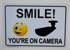 Smile You'Re On Camera   Building Sign
