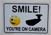 Smile You'Re On Camera   Building Sign