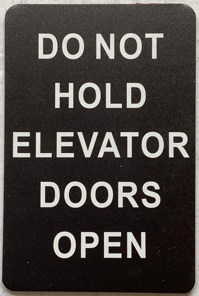 DO NOT HOLD ELEVATOR DOORS OPEN sign