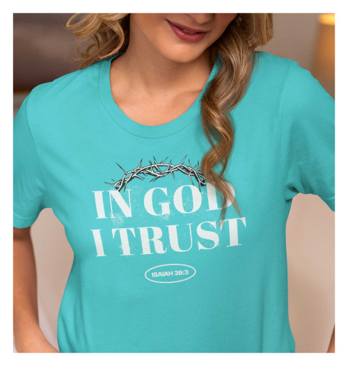 Young woman modeling 'In God I Trust' Christian T-Shirt in Tahiti Blue, featuring Isaiah 26:3 scripture, unisex athletic fit.