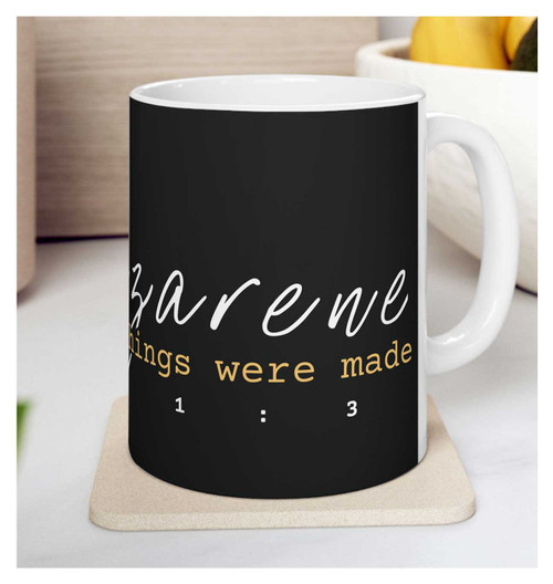 "The Nazarene" Christian coffee mug in black and white sitting on a drink coaster.