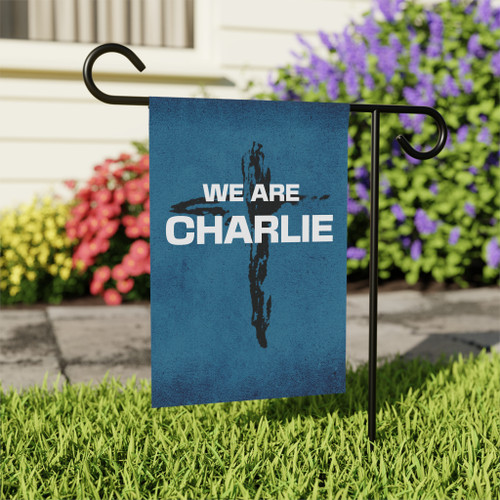 Blue 'We are Charlie' Garden Flag with cross background displayed on the front lawn