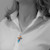 YHWH Nissi Mahogany Wood cross pendant worn by a woman.
