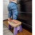 Child standing on her tip-toes while on a Purple Grape Gumdrop Step Stool.