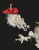 Textural Cascade —

Flowing chenille velvet strands
Intertwined eyelash yarn for softness and movement
Waterfall of hand‑crafted miniature flower bulbs
Embellished with glass beads and pearl accents