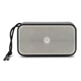 A rectangular grey bass speaker with a mesh front and a black cord attached for easy carrying.