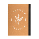 A brown A5 notebook with a black spine and a logo featuring a leaf and berries on the cover.