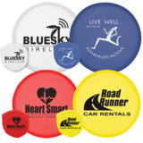 A collection of colorful flying discs in red, yellow, blue, and white, featuring various logos and branding.