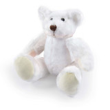 A soft, white plush teddy bear with pale yellow accents sitting with its arms and legs spread out.