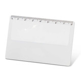 A card magnifier with a ruler along the top edge and a clear, smooth surface.
