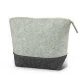 A cosmetic bag featuring a soft green upper section and a dark grey base, with a zip closure and no visible branding.