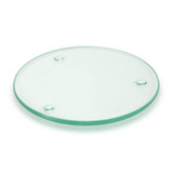 A round, transparent glass coaster with three small feet for stability.