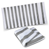 A striped beach towel in grey and white, displayed flat and folded, featuring a logo.