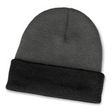 A two-toned beanie featuring a grey body and a black cuff. It has a logo on the side.