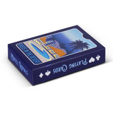 A blue playing card deck featuring a design of a motel and palm trees. The box has a logo and artistic details.