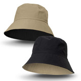 A reversible bucket hat featuring a beige side and a black side, with a logo on one side.