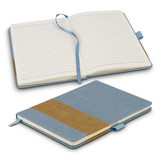 A denim notebook featuring a blue cover with a brown faux leather strip, showcasing lined pages and a ribbon bookmark.
