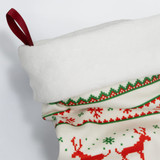 A festive Christmas stocking in white, red, and green, featuring a soft top and decorative patterns.