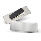A metallic name badge featuring a silver finish with a black magnetic backing and an attached clip.