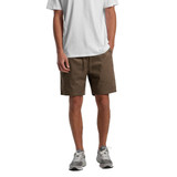 A pair of brown walk shorts with a drawstring, worn by a model standing in a casual outfit.
