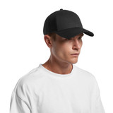 A black trucker cap with a mesh back, worn by a person in a white t-shirt. The cap features a logo.