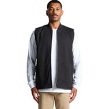 A heavy black canvas vest with a zip front and two pockets, worn over a white long-sleeve shirt.