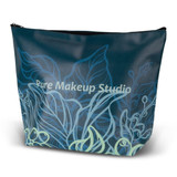 A large cosmetic bag in dark teal featuring floral designs, with a logo and a zippered top for closure.