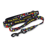 A colourful dog leash featuring various cartoon motifs and a clip for attachment, along with a branding logo.