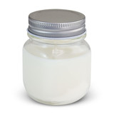 A white scented candle in a glass jar with a silver metal lid. The jar has a smooth finish and a simple design.