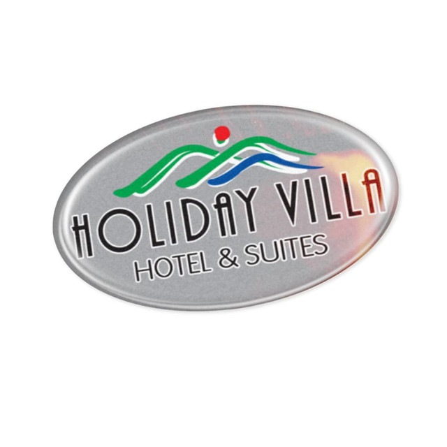 An oval sticker featuring colourful design elements and a logo, with the words "Holiday Villa Hotel & Suites" in bold.