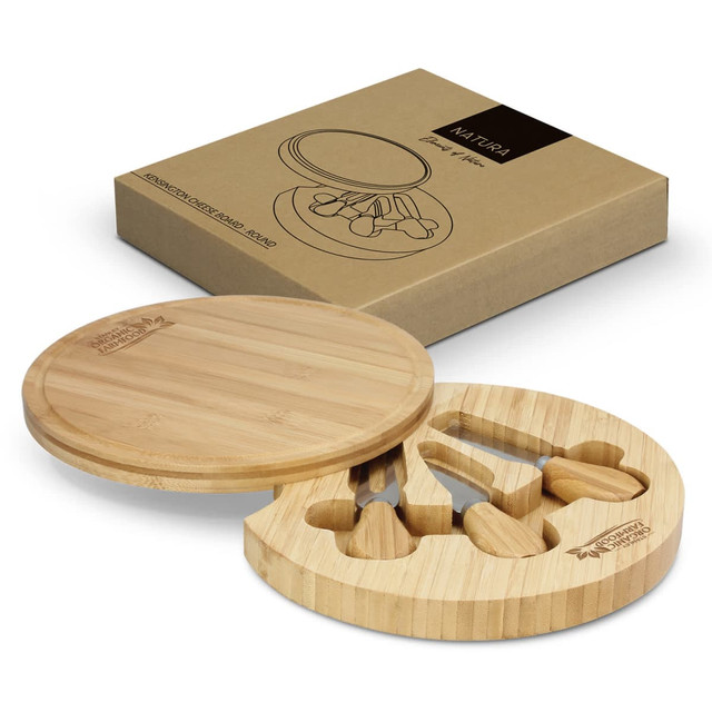 A round bamboo cheese board with three cheese knives, displayed in a cardboard box with a logo.