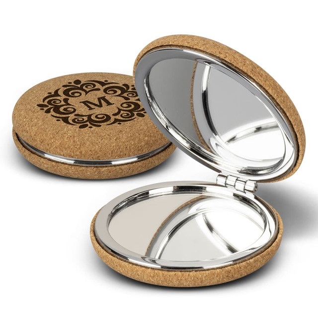 A cork compact mirror featuring a decorative design and a shiny interior for reflection.