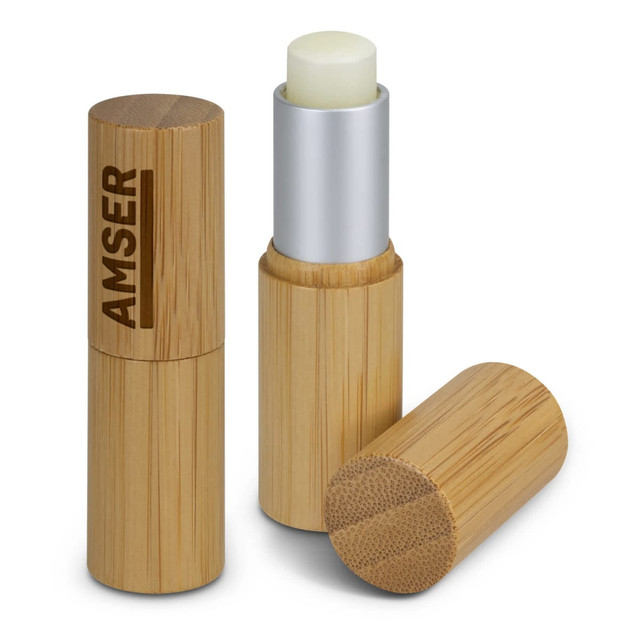 A bamboo lip balm container in natural colour with a silver top and a visible branding element.
