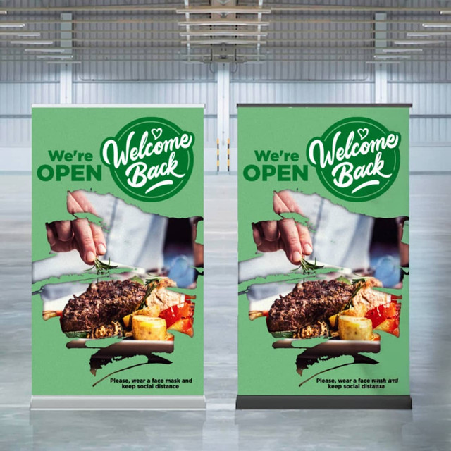 Two luxury pull-up banners in green featuring food imagery and a logo, set in a spacious indoor event space.