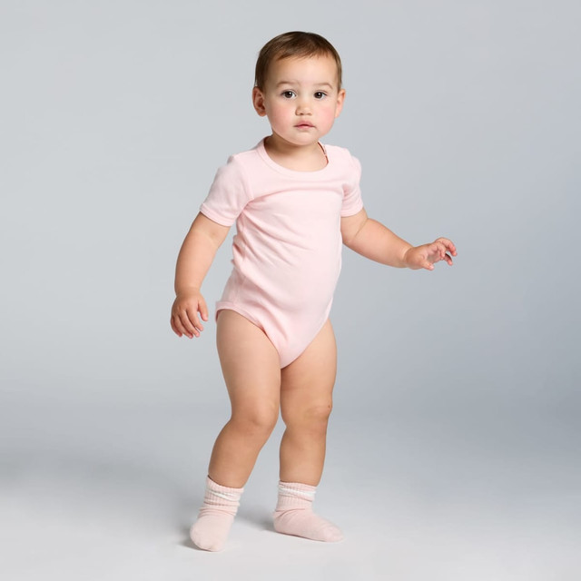 A pink organic infant one-piece with short sleeves and a rounded neckline, featuring a fitted design.