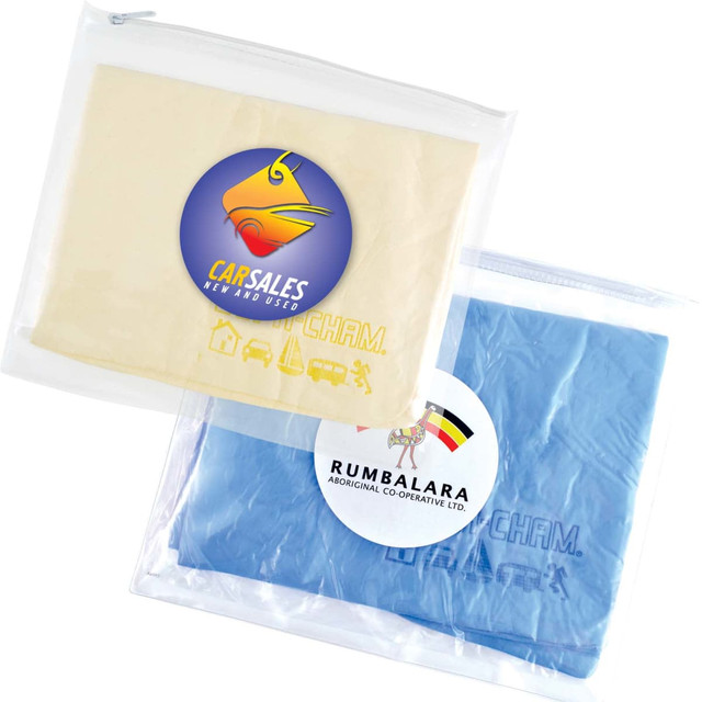 A clear pouch containing a cream-colored and a blue chamois cloth, each with a logo.